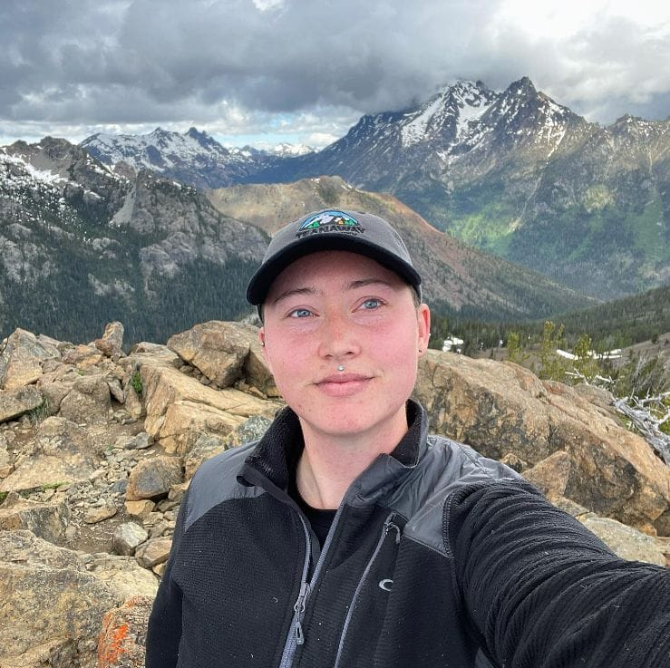 Vince Pruis standing in front of a view of Mount Stuart