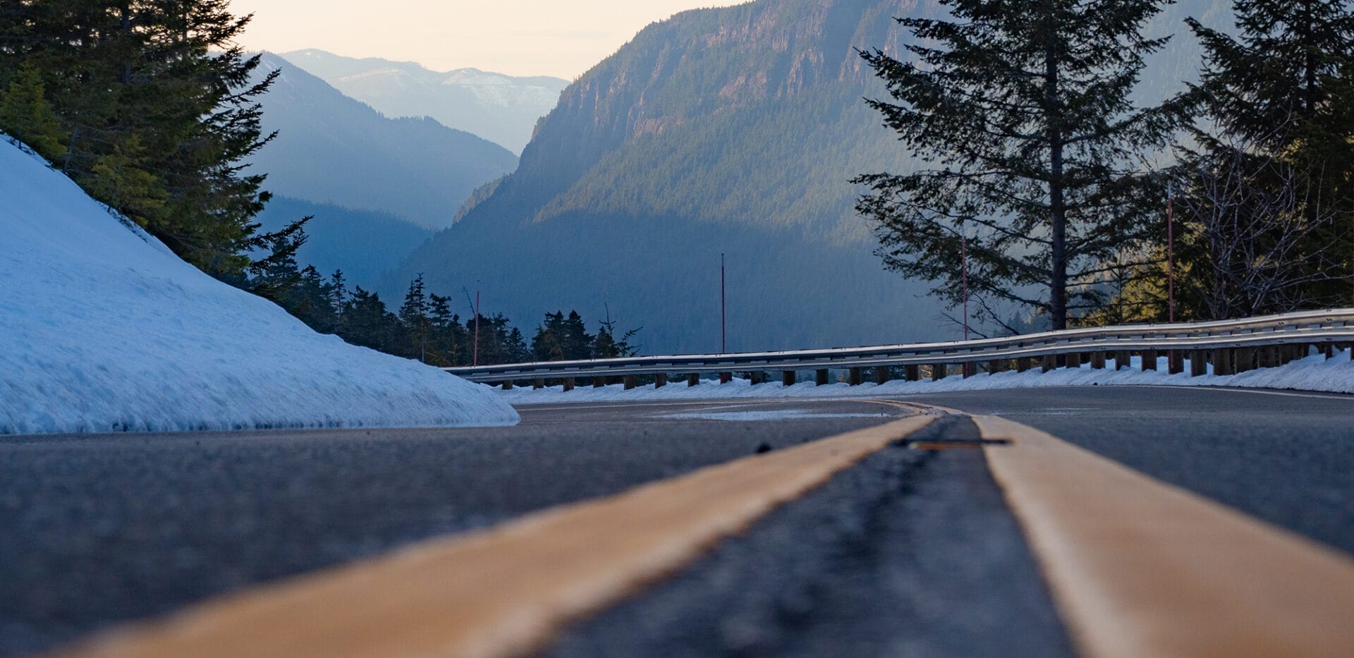 Road extending off into the distance with mountains in the background