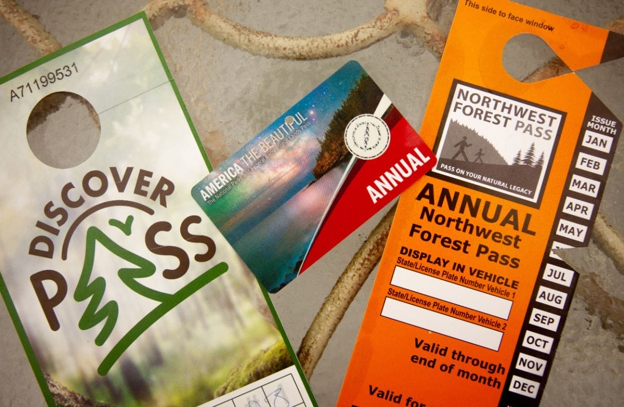 Photo shows three different recreation passes that may be required at different areas within Washington state.