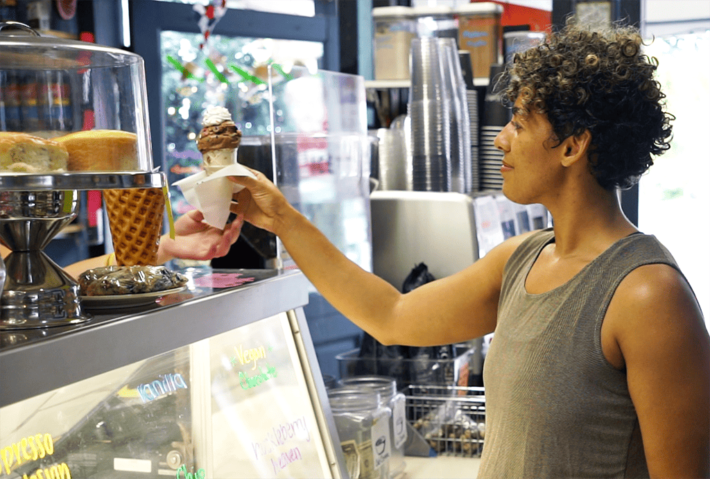 Person grabbing icecream over the counter at an ice cream shop in Duvall