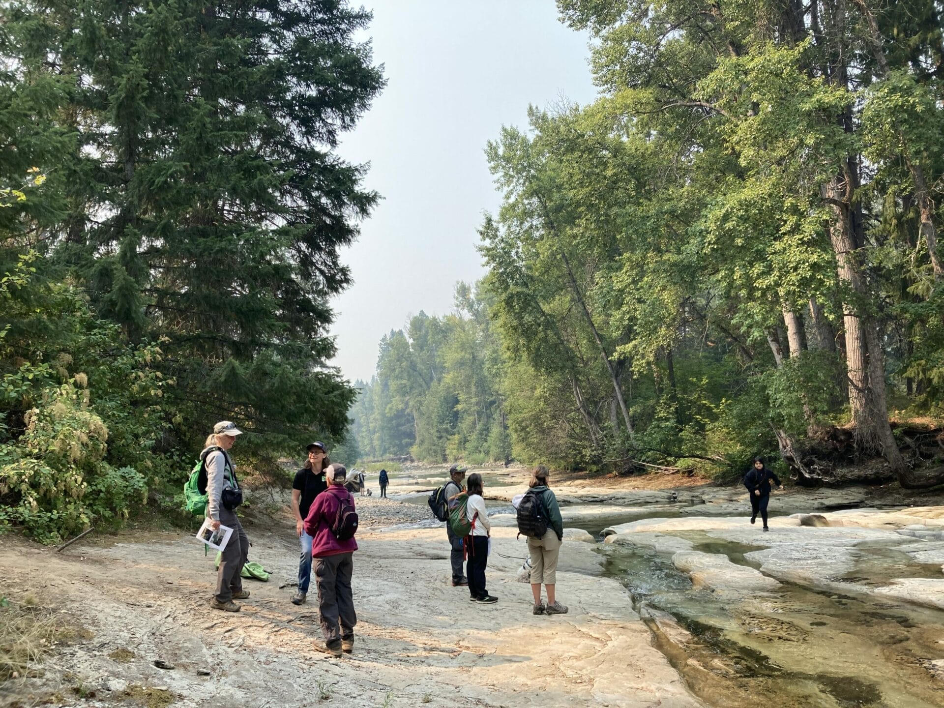 Teanaway Rivers Walk participants stand on exposed sandstone bedrock of North Fork Teanaway River.