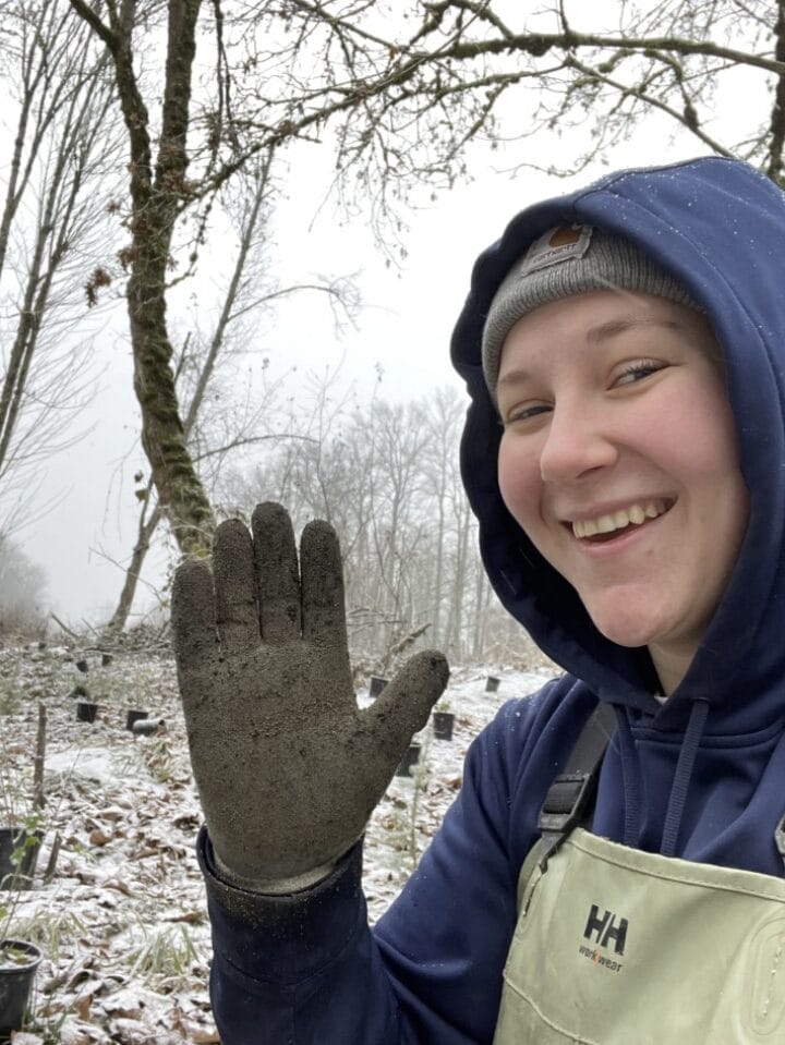 Darla Seehusen-Besky waving in snowy forest