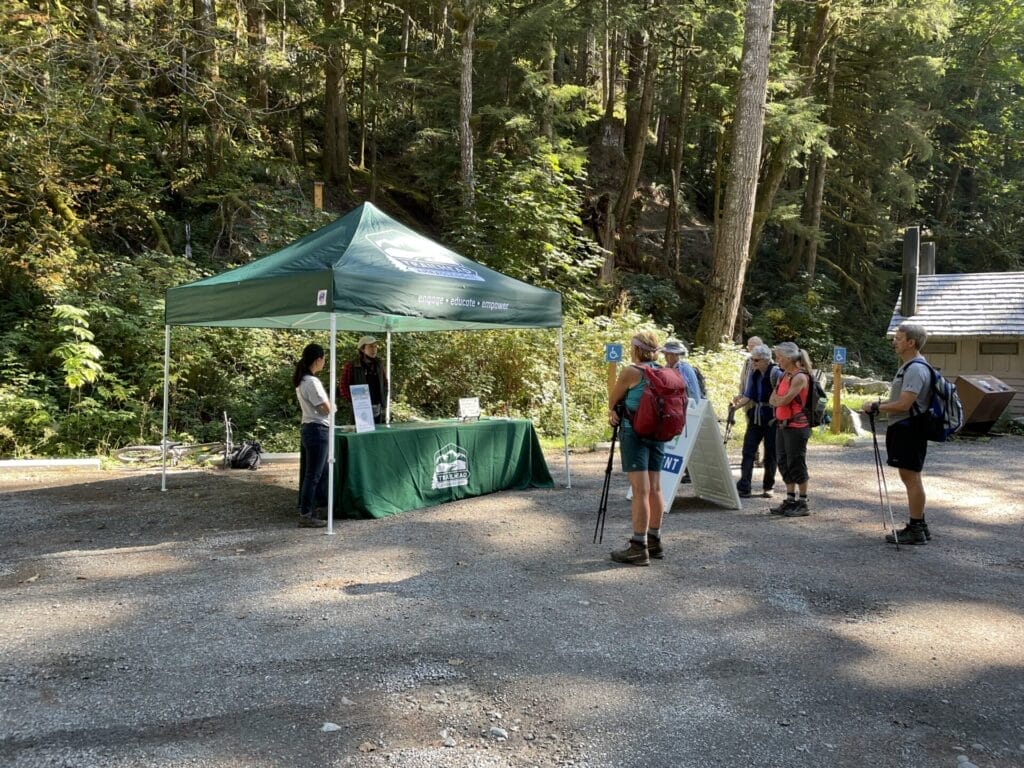 Volunteer Trailhead Ambassadors help hikers at a trailhead